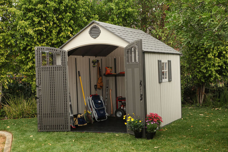 Lifetime resin storage shed with double doors open showing tools and equipment inside