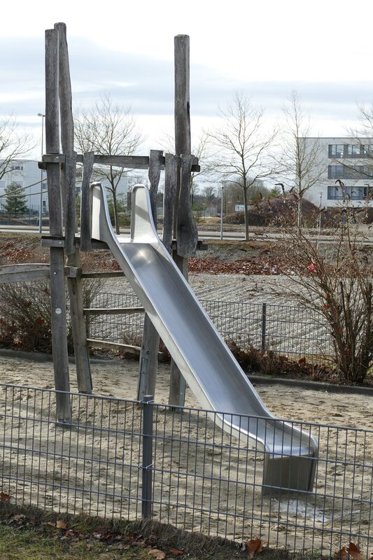 Modern stainless steel playground slide with wooden post supports